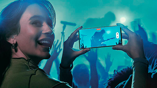 person holding a samsung galaxy s23 ultra at a concert