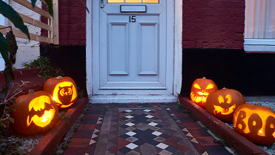 pumpkins outside a door