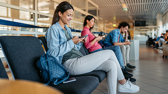 Girl at airport using phone