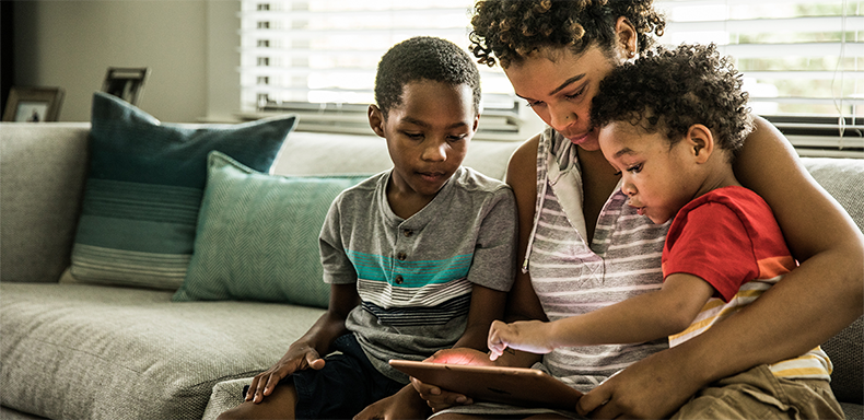 Two childen and parent on the ipad