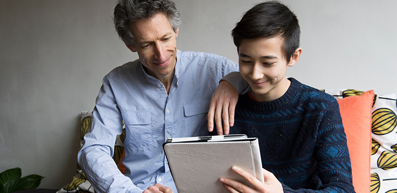 Father and son using the pad